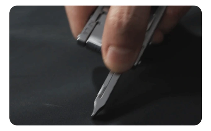 Razor blade dragged across the shell fabric without piercing it